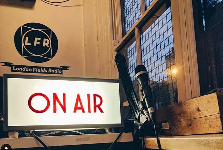 A corner of a radio studio, which has a microphone and a light up