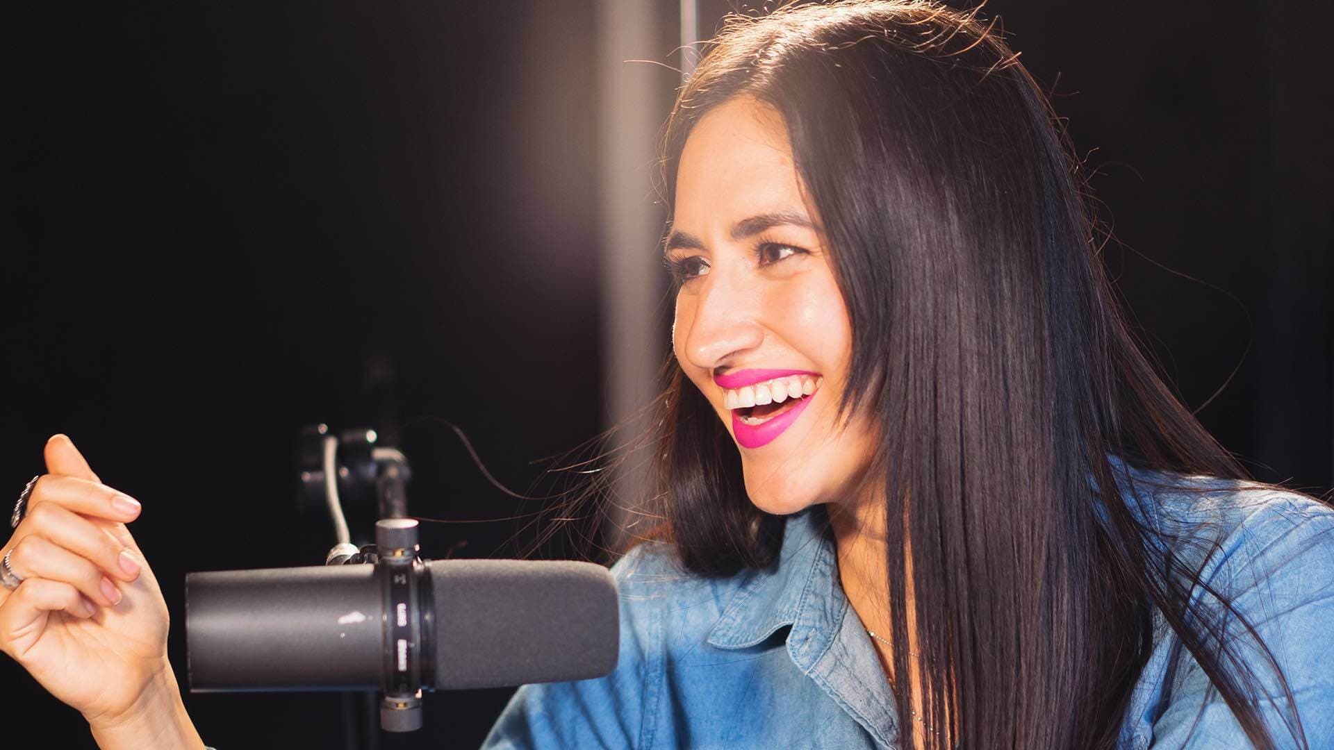 Woman having a good time behind the microphone.
