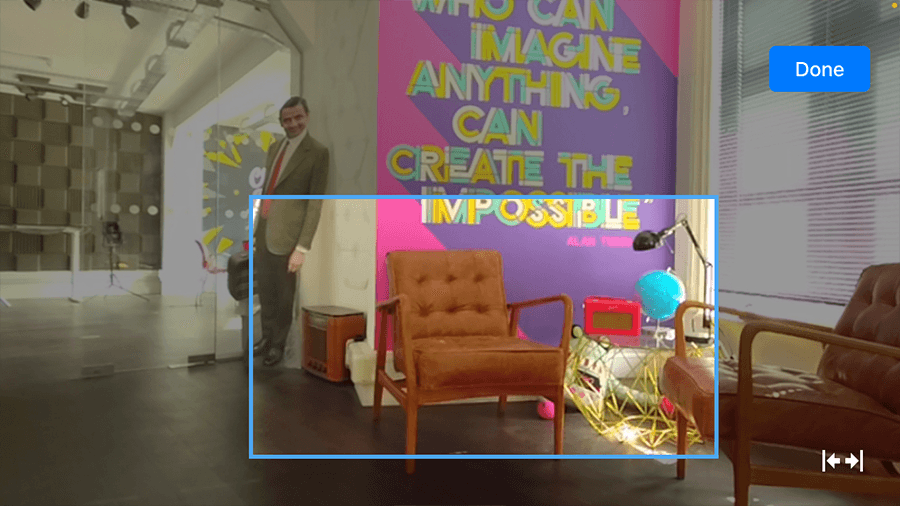 A screenshot from the Mevo Multicam app showing the view from a mevo: an office space with a blue outlined square to indicate where the frame will be cropped to.
